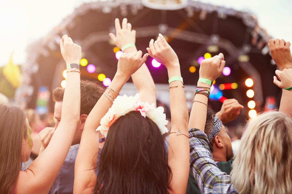 Audience with hands in air at festival
