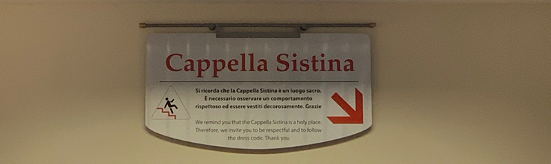 Sign directing you down to the Sistine Chapel.