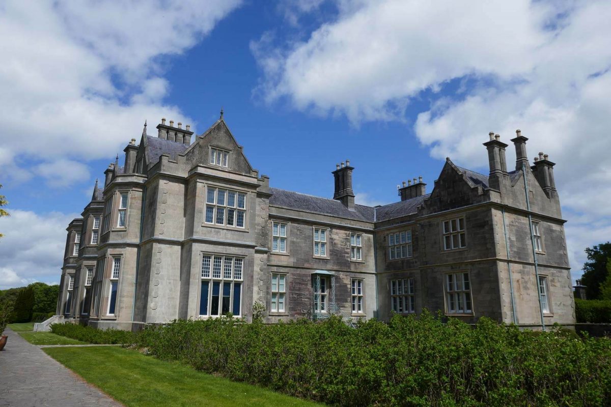 View of grey bricked stately manor house 
