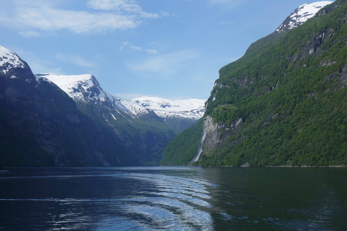 Steep snow capped mountains either side of water