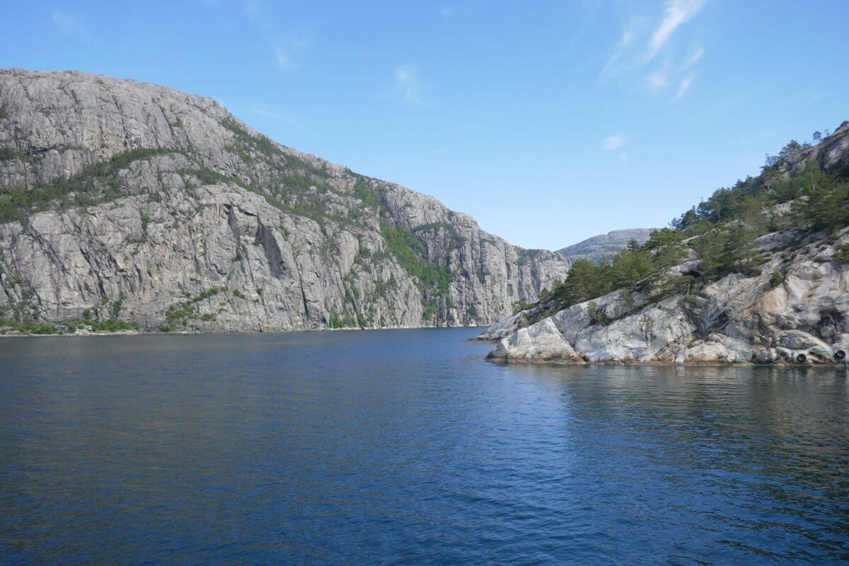 view of the fjords craggy rocks against the sea and sky