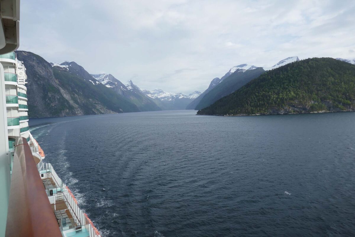 image of a narrow channel of sea between two sides of snow capped mountains
