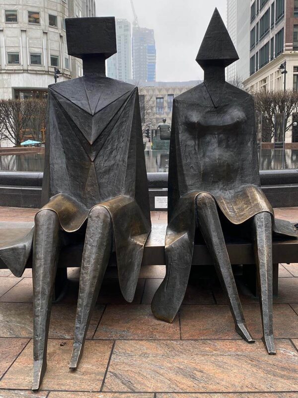 image off public art in Canary Wharf, a metal installation of two people sitting on a bench