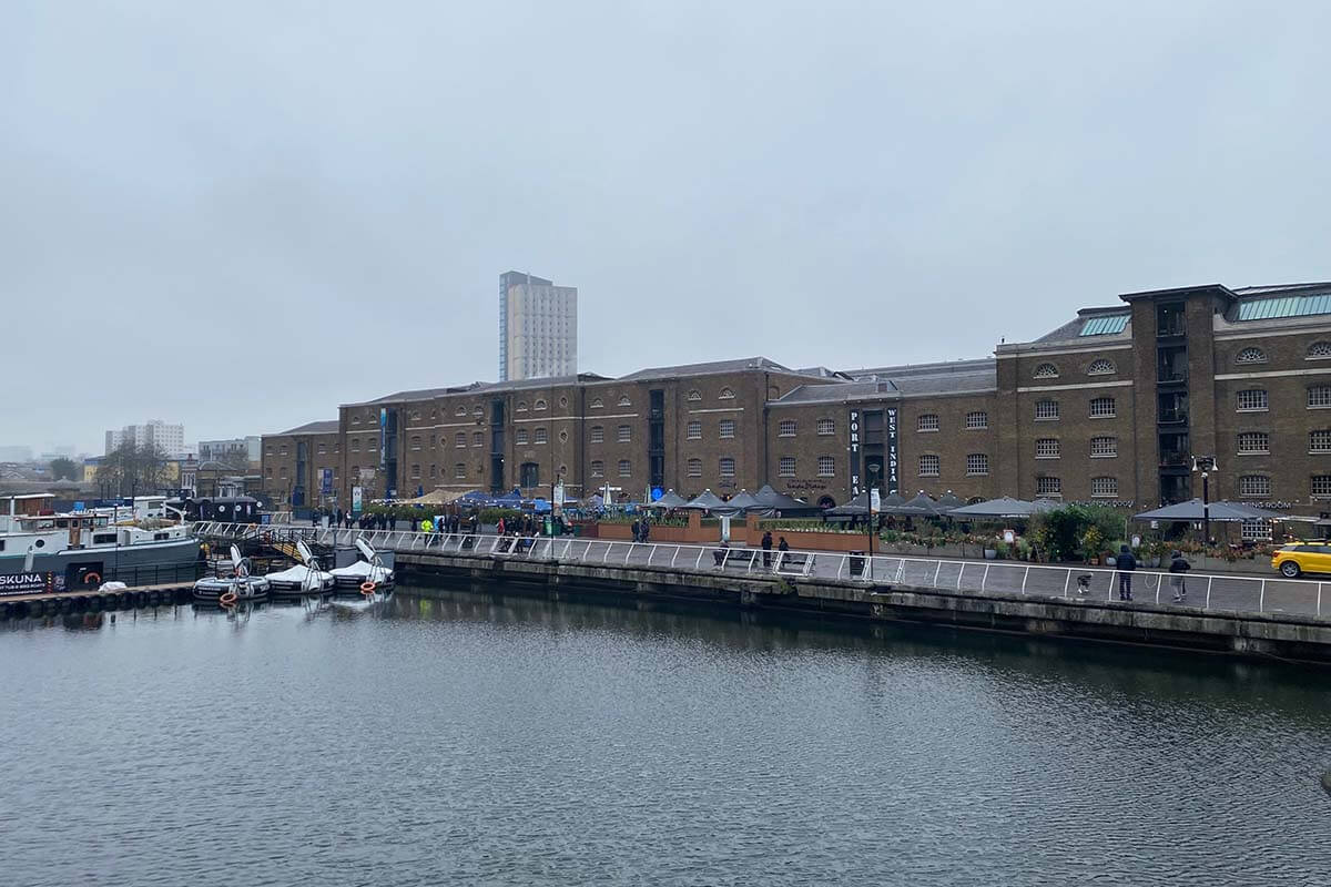 image of warehouse along the riverfront with restaurant and bars outside