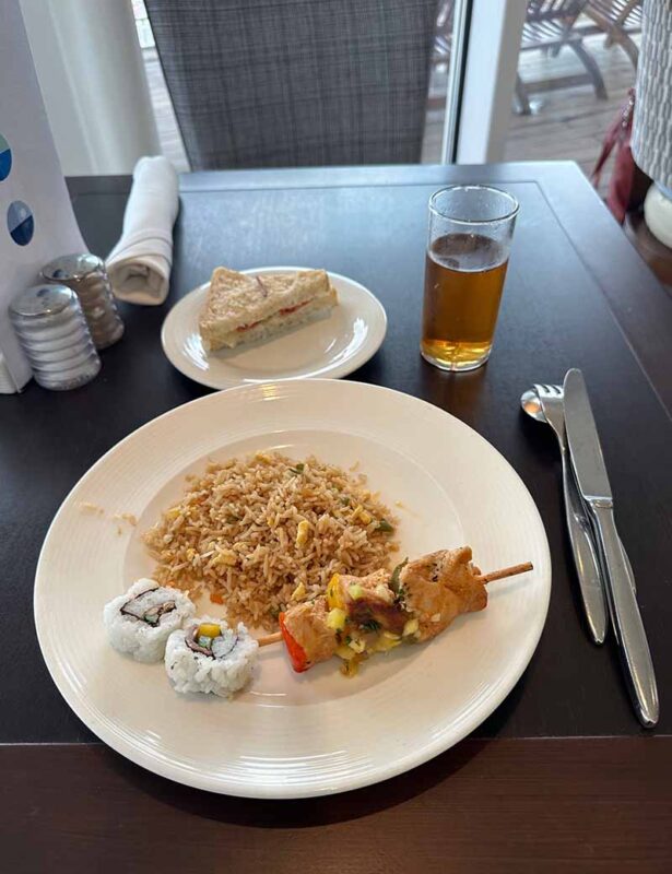 image of food on a white plate with a drink by the side.