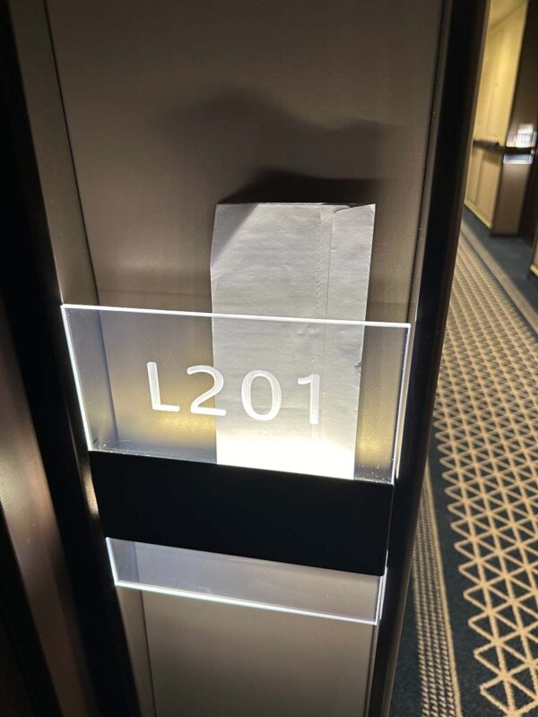 Door number and post box next the door of a cruise ship cabin.
